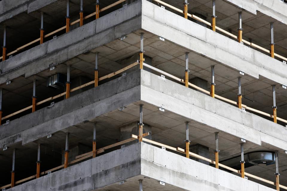 Reinforcement steel tied over the first floor slab of a block house, props still in place underneath
